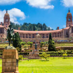 The Union Buildings and gardens in Pretoria, South Africa. This is where parliament is held in South Africa every six months alternatively with Cape Town. Tourists can be seen around Nelson Mandela statue in the centre.